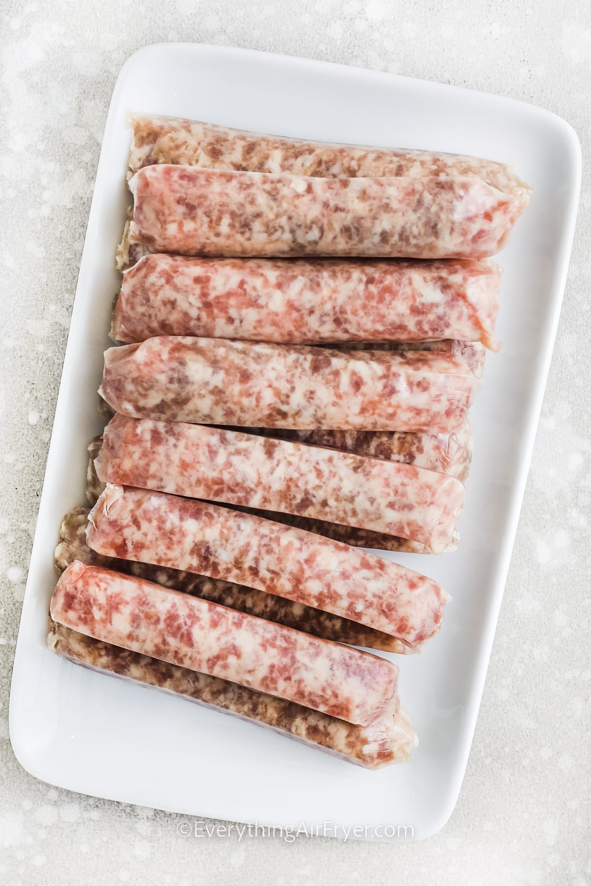 raw breakfast sausages on a plate for Air Fryer Breakfast Sausages