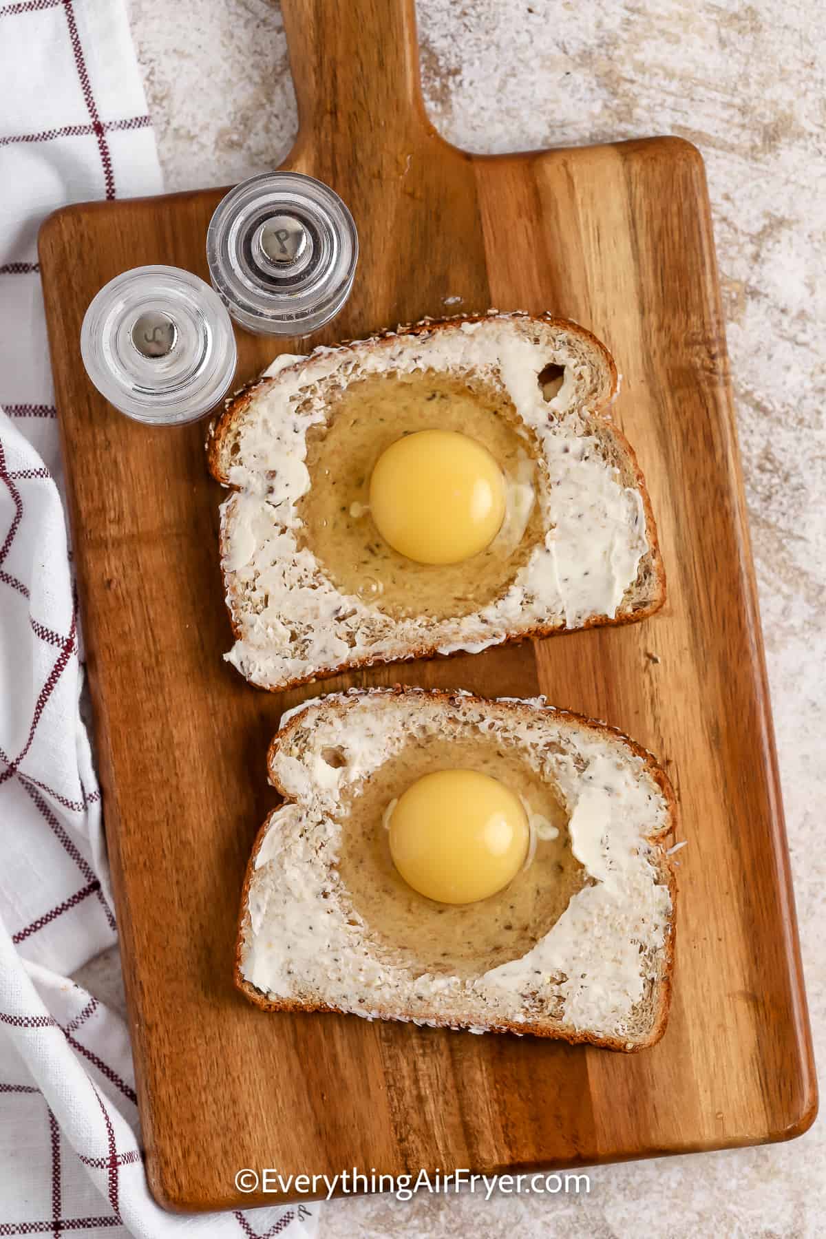 egg in a hole prepared on a cutting board