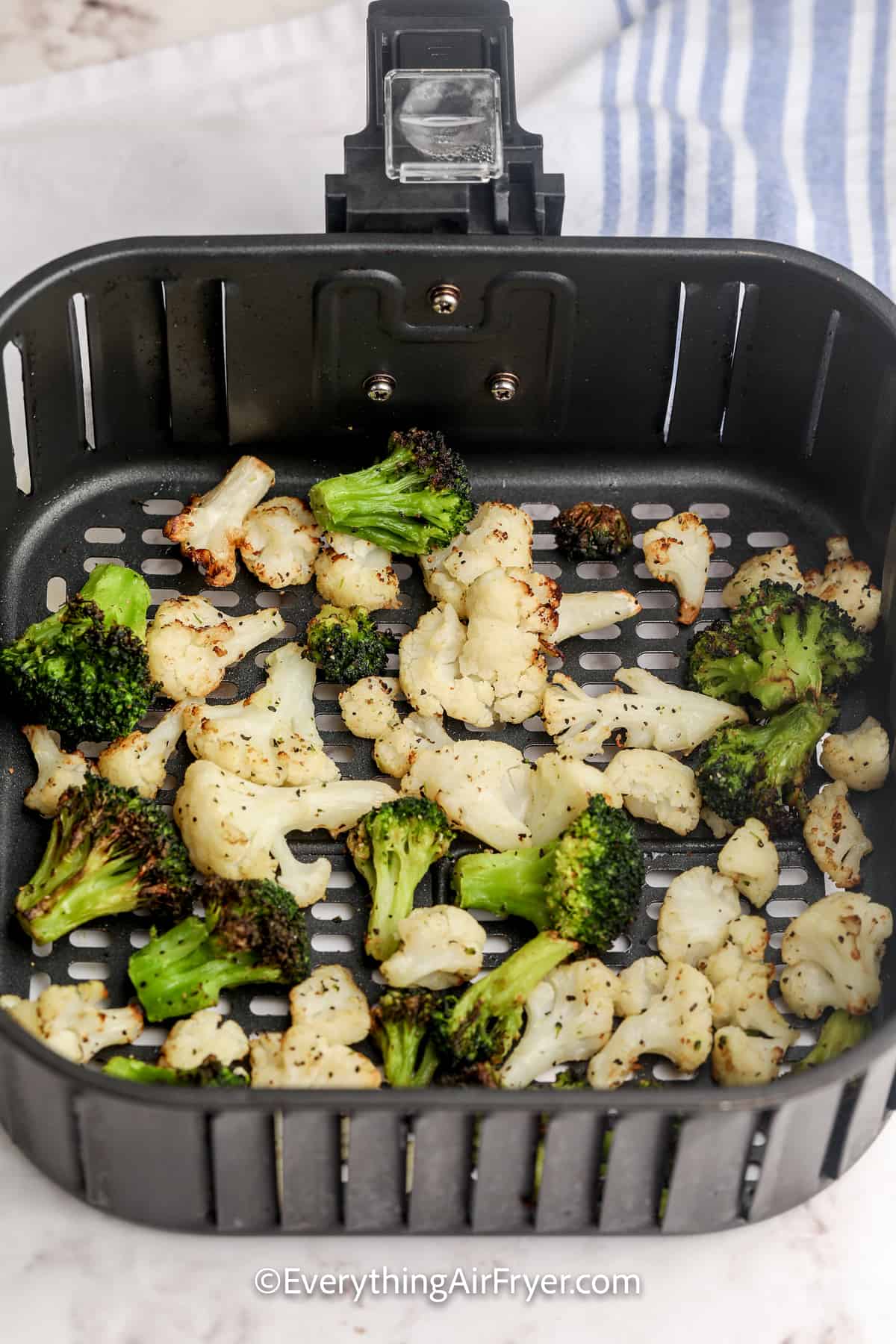 cooked vegetables in an air fryer basket for Air Fryer frozen vegetables