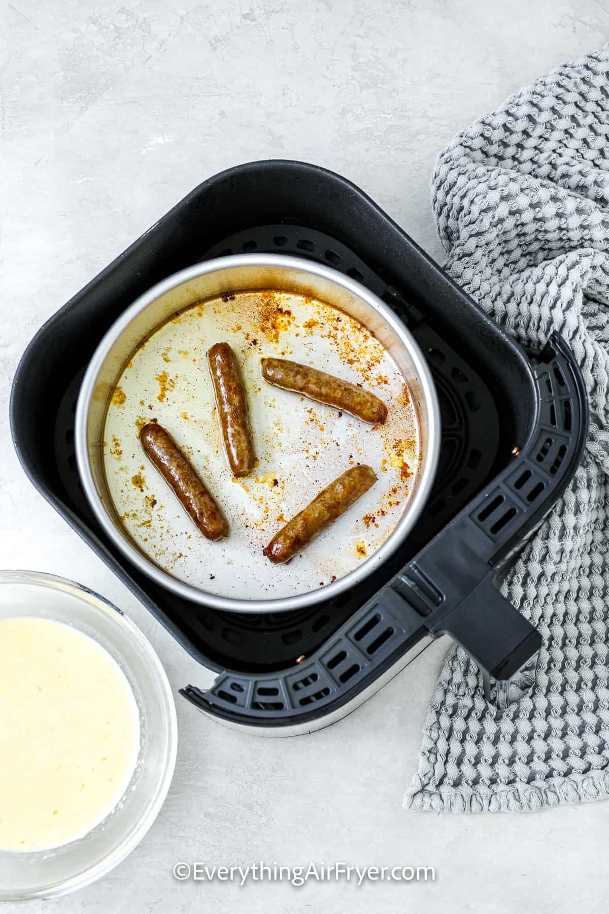 cooked sausages in an air fryer tray