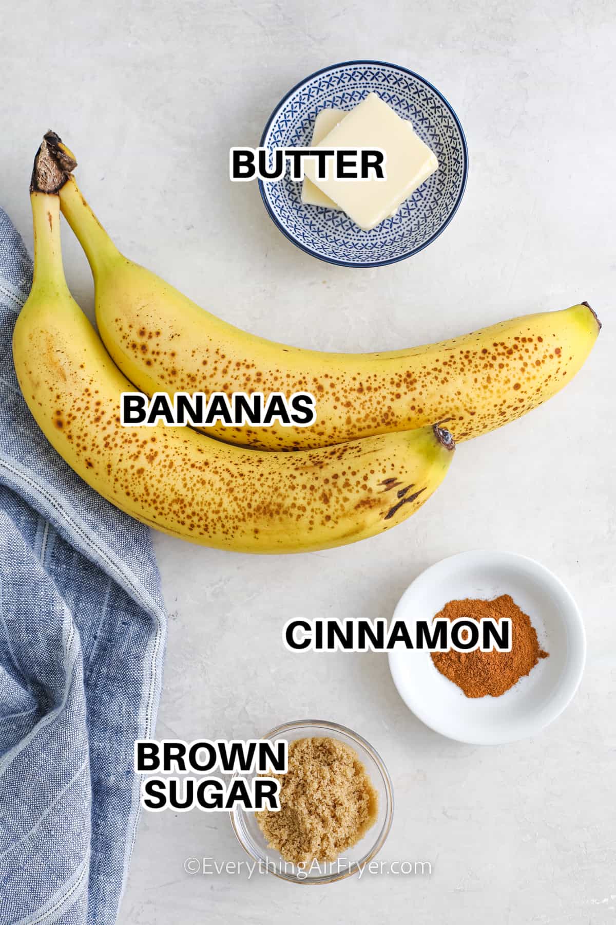 ingredients assembled to make air fryer bananas, including bananas, butter, cinnamon, brown sugar, and butter
