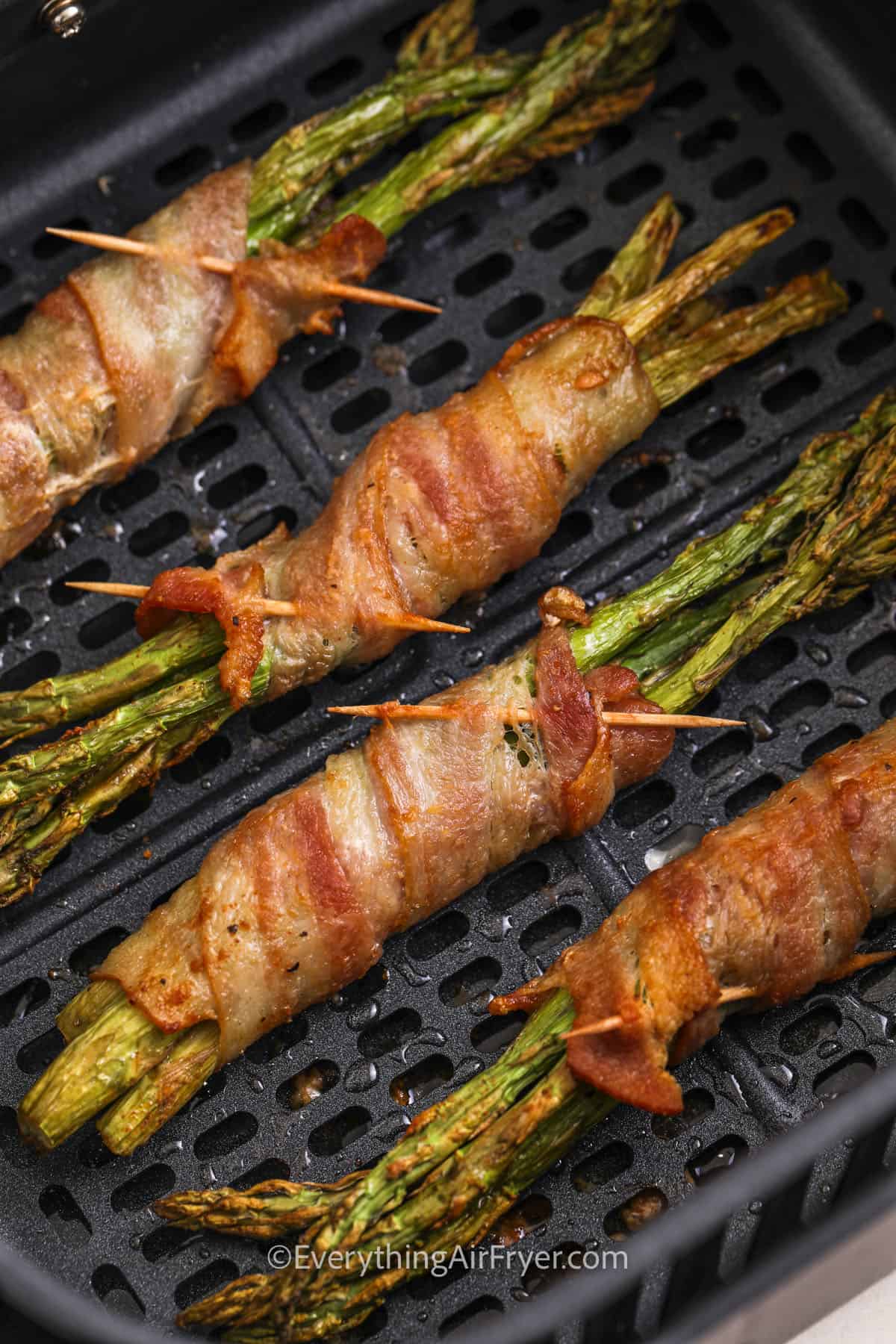Air Fryer Bacon Wrapped Asparagus in the fryer