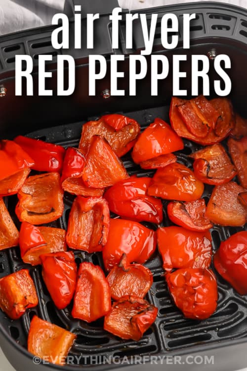 Red peppers in an air fryer basket with text