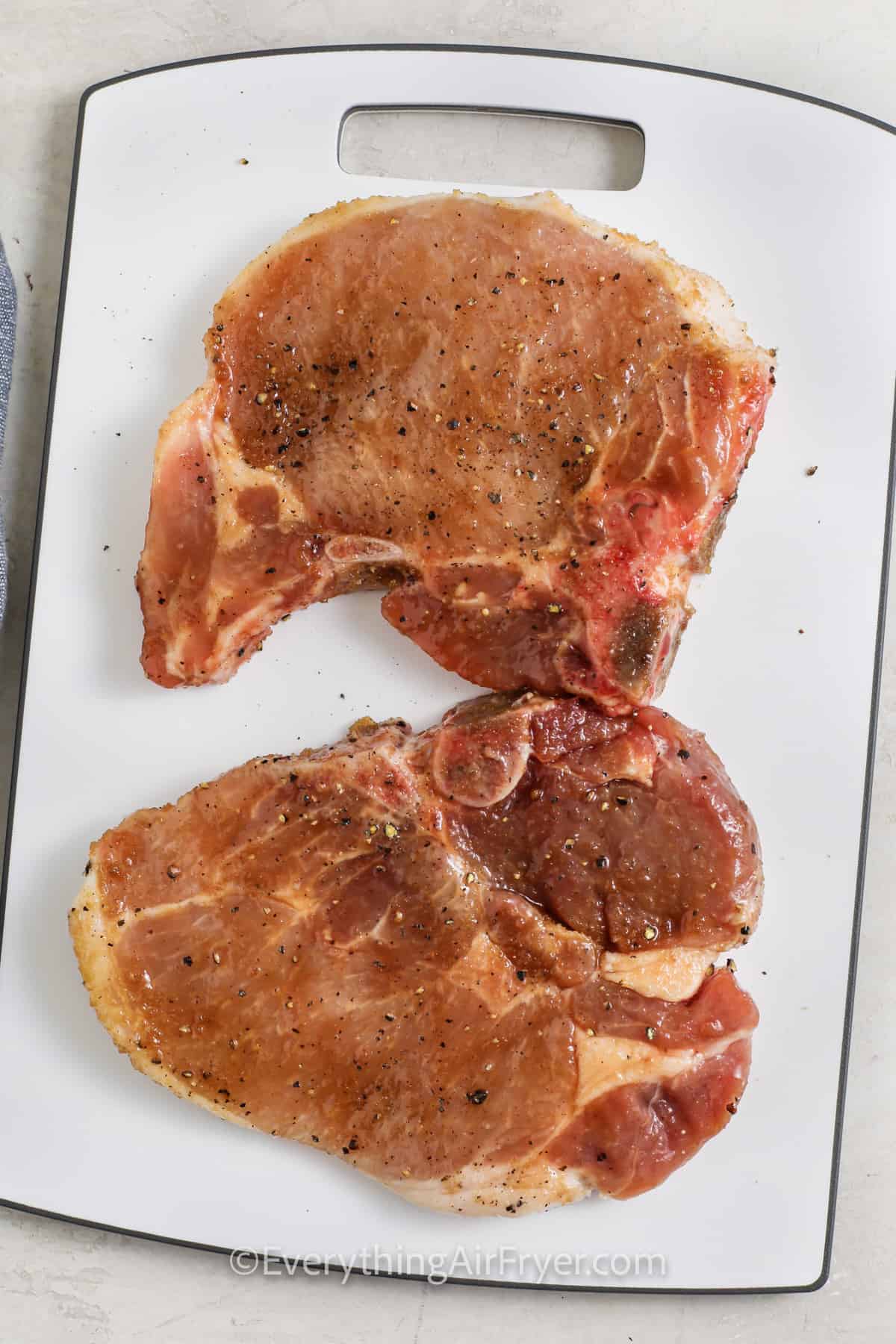 adding seasonings to Air Fryer Bone In Pork Chops