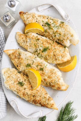 close up of Air Fryer Tilapia on a plate with lemon slices