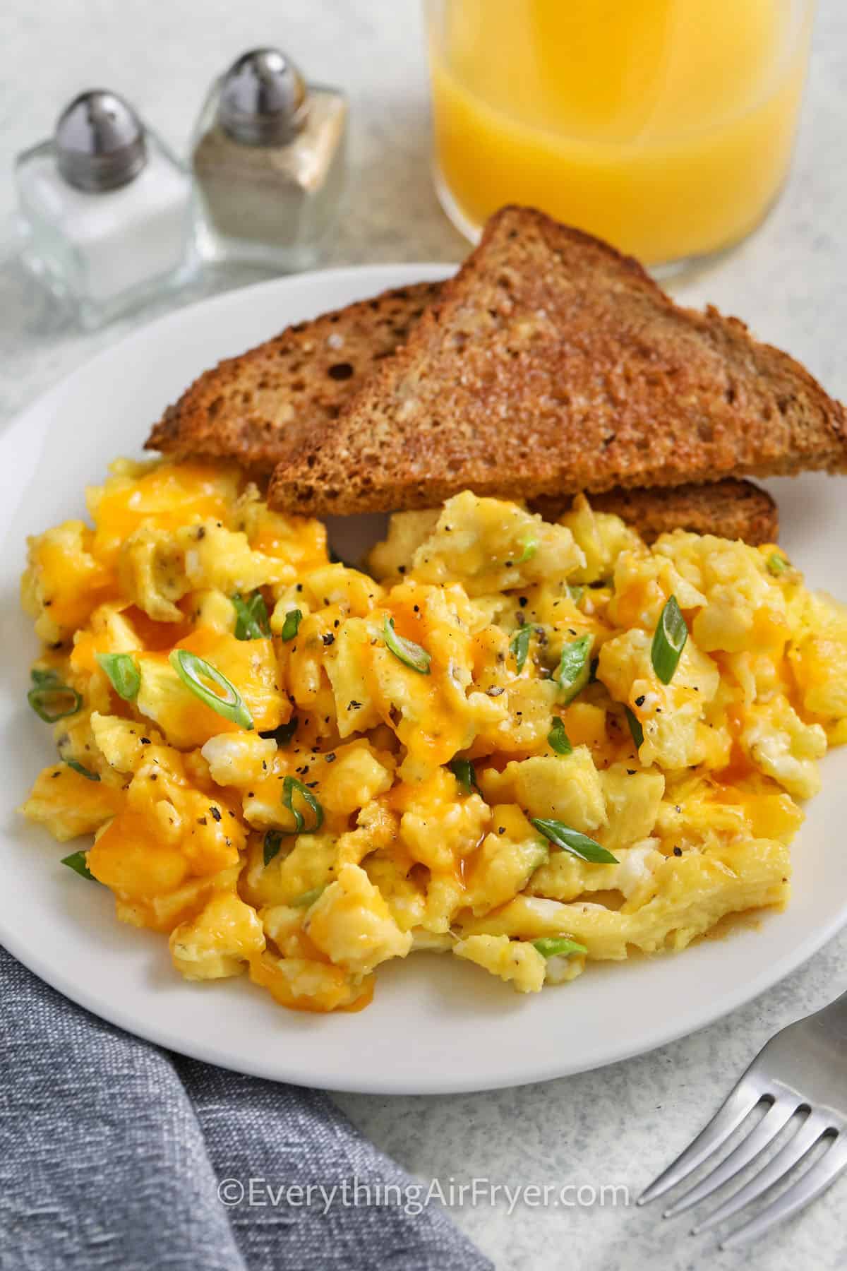 scrambled eggs and toast on a plate