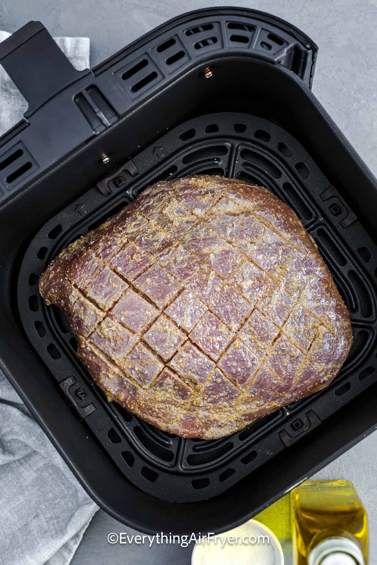 Seasoned Flank Steak in an air fryer basket