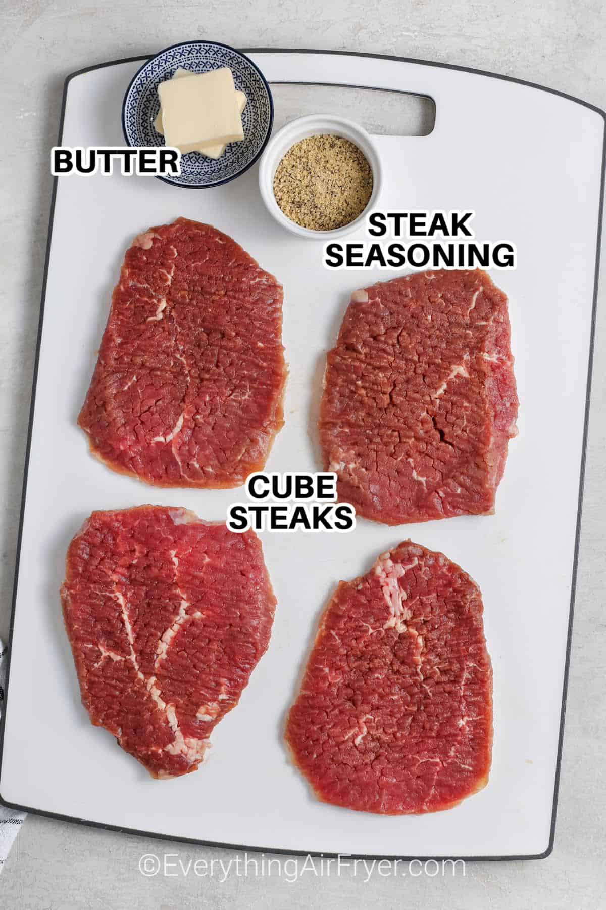 ingredients to make air fryer cube steak labeled: butter, steak seasoning, and cube steaks