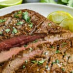 Air Fryer Flank Steak sliced on a serving plate with a title