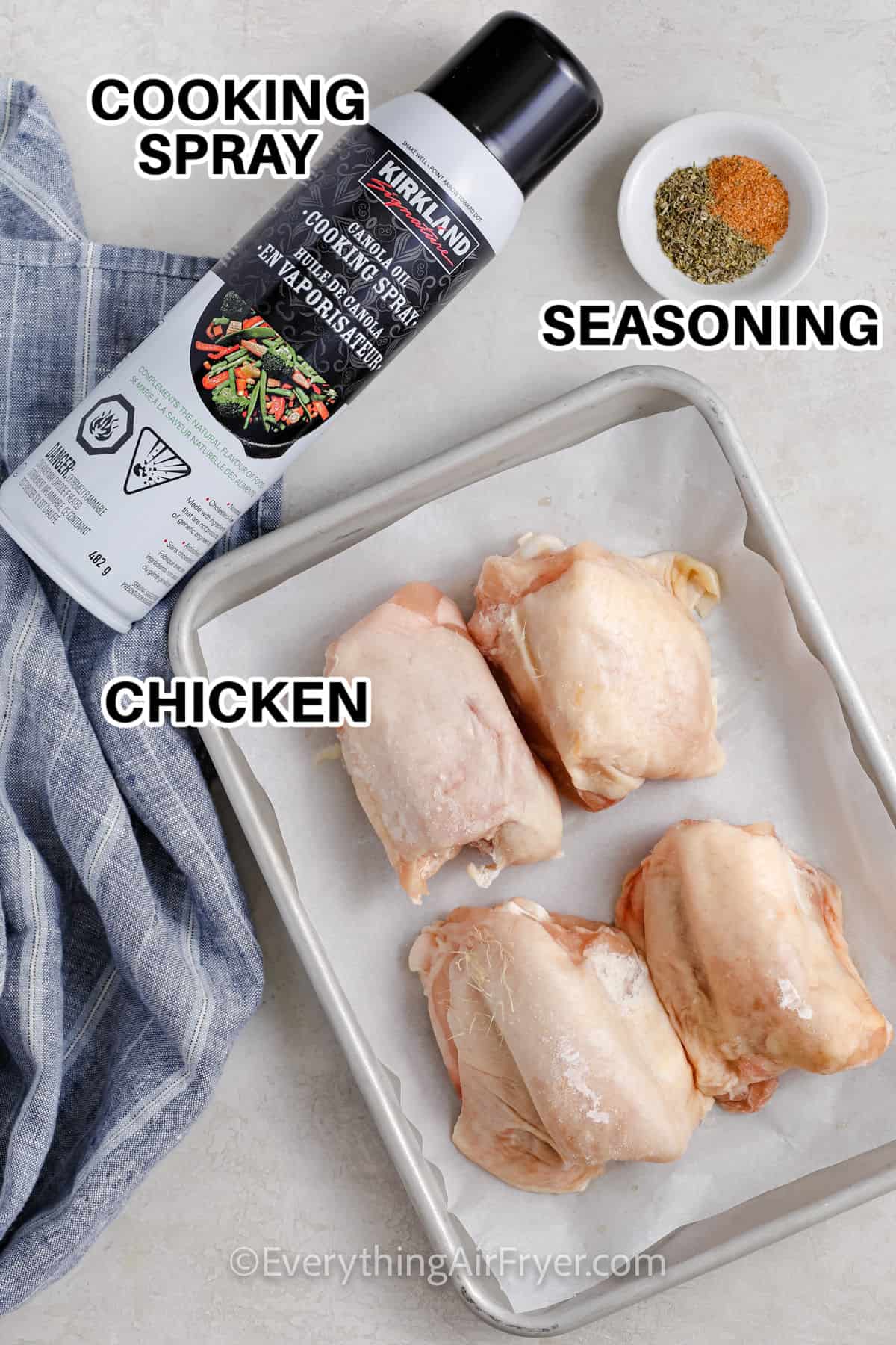 cooking spray , seasoning and chicken with labels to make Frozen Chicken Thighs in Air Fryer